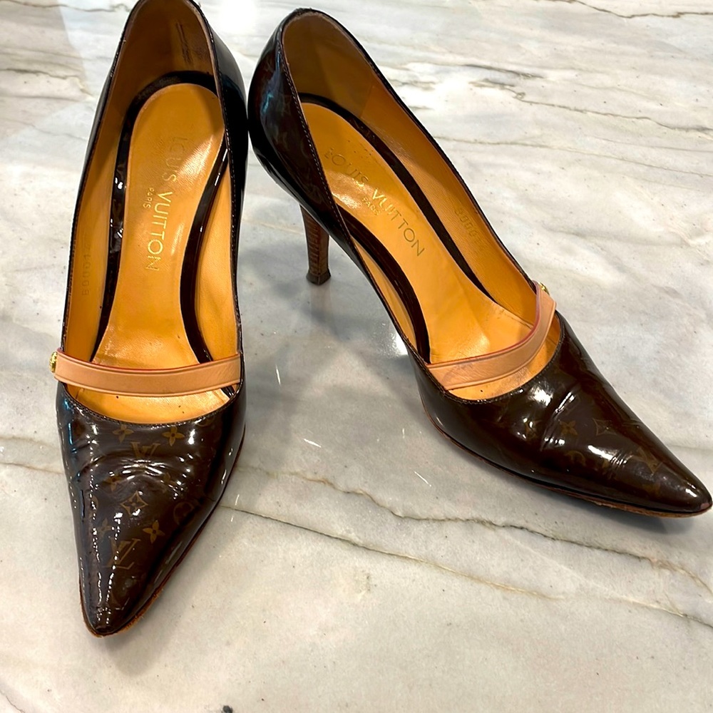 Louis Vuitton brown patent pumps with stacked wood heel and Mary jane strap.